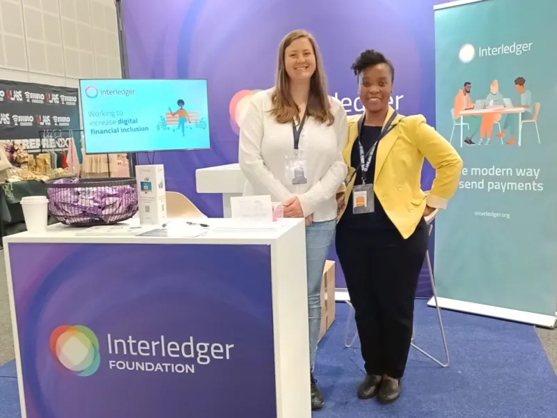 Interledger team members standing at their booth at the AfriLabs gathering