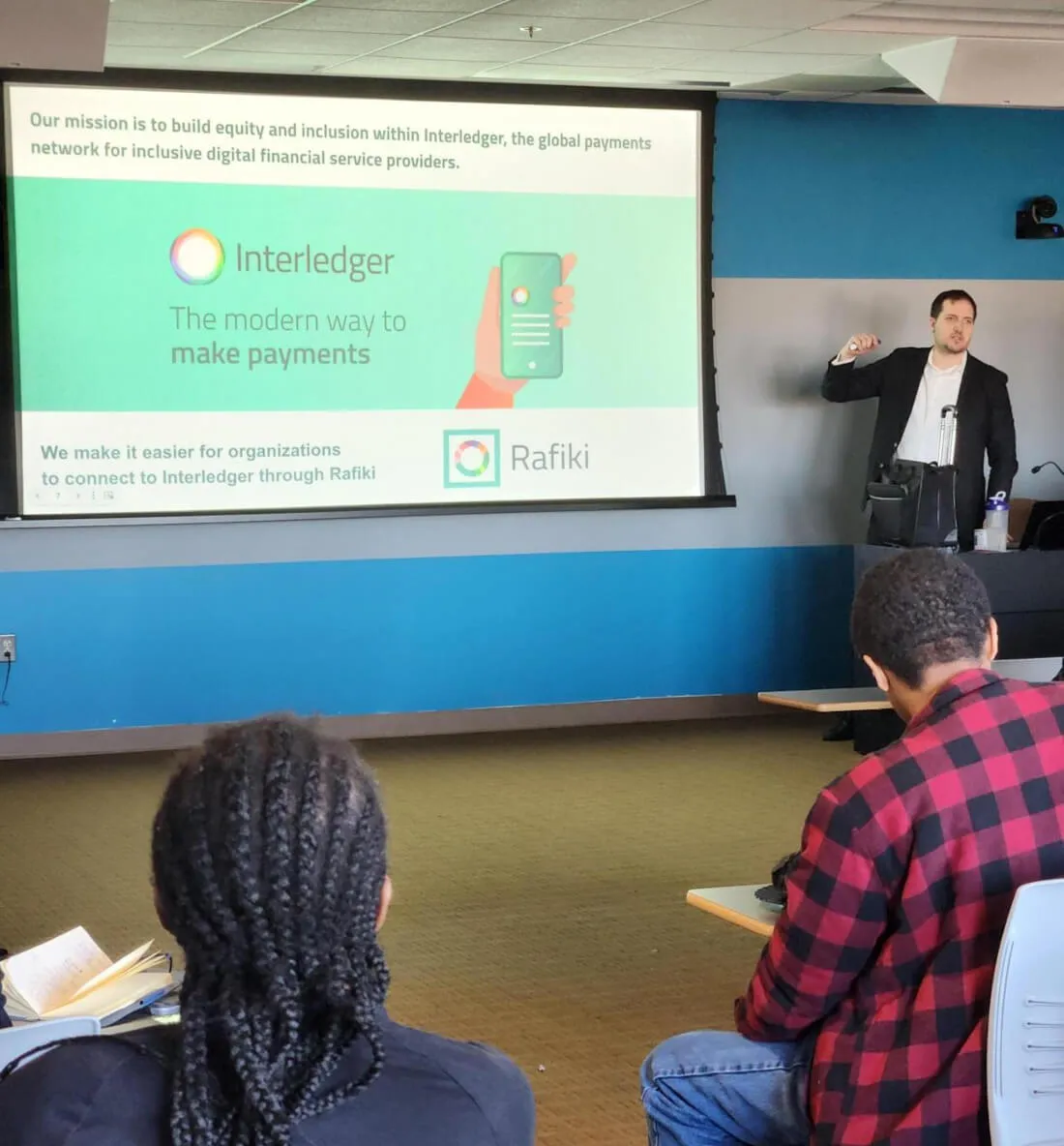 Dr. Andrew Mangle delivering a presentation on Interledger to a classroom of university students.