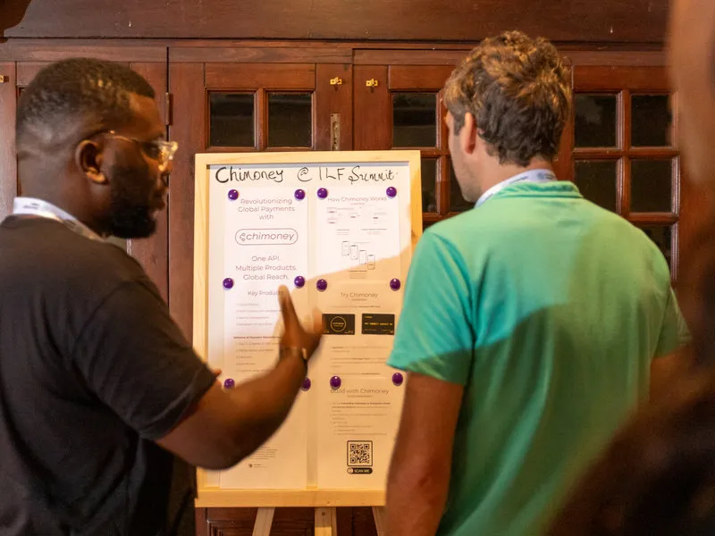 Uchi Uchibeke speaking with an attendee at the Interledger Summit