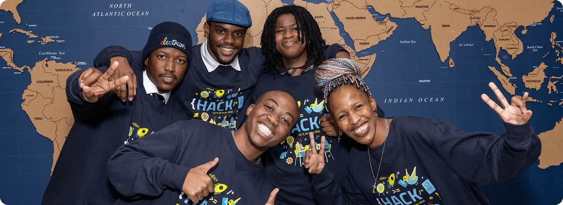 Team of five students smiling and posing together at the Interledger Hackathon.