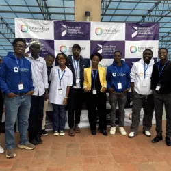 Participants at USIU-Africa pose in front of a banner featuring Interledger Foundation and USIU-Africa logos.