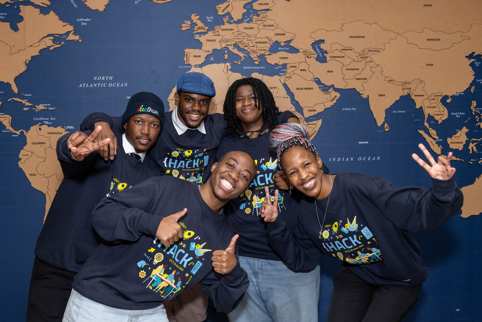 Group photo of students smiling for the camera at a hackathon.